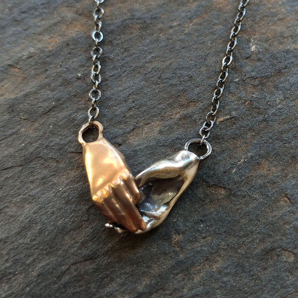 Bronze and Silver Holding Hands Necklace